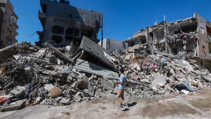 A boy inspects the damage at the site of an overnight Israeli strike in the southern city of Tyre, Lebanon, May 23, 2026. | REUTERS/Aziz Taher