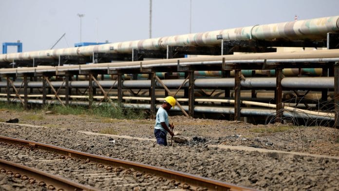 A man works close to pipelines of liquid cargo, near the Deendayal Port in Kandla, in the western state of Gujarat, India, September 26, 2024. | REUTERS/Amit Dave
