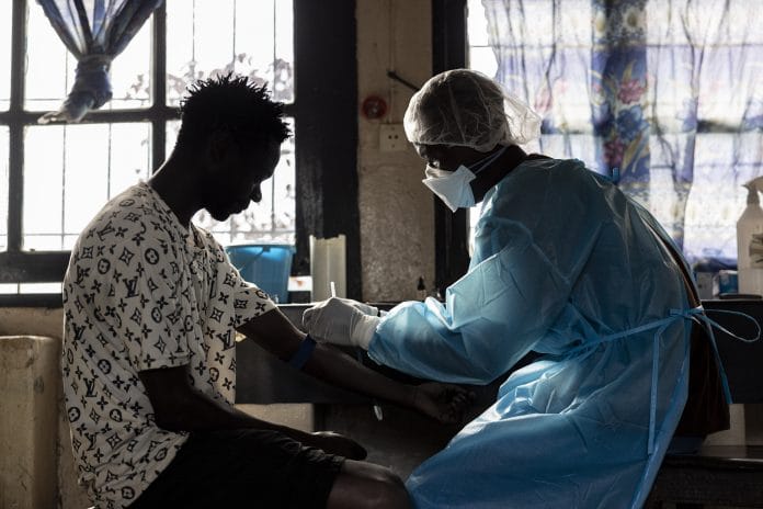 A patient prepares to have blood drawn for a test at General Referral Hospital of Mongbwalu during the Ebola outbreak response in Mongbwalu, Ituri province, Democratic Republic of Congo on May 20. | Michel Lunanga/Getty Images