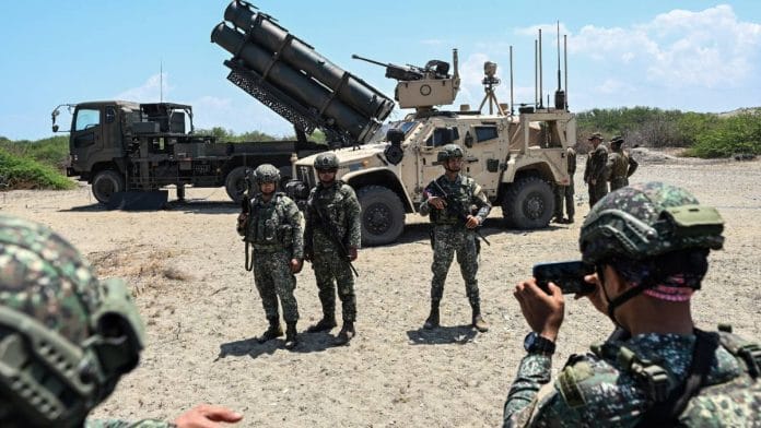 Philippine soldiers in front of the Japan Ground Self-Defence Force (JGSDF) Type 88 surface-to-ship missile launcher and the US Marine Air Defense Integrated System (MADIS), during the Joint Task Force (JTF) Maritime Strike, part of Balikatan military exercises | Reuters