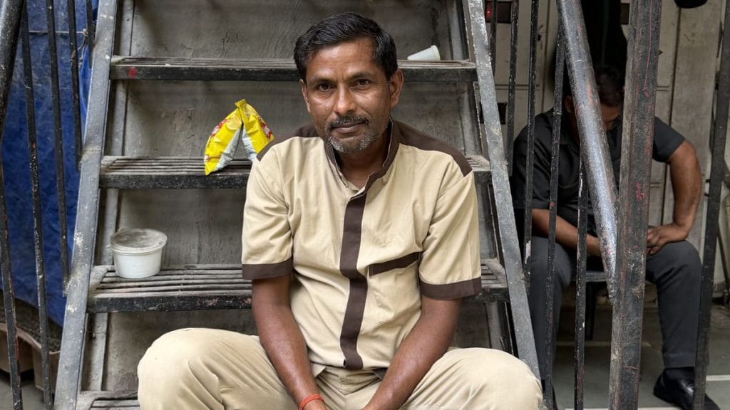 Suresh sits outside Naivedyam, a south Indian restaurant, during his short break from work. Triya Gulati | ThePrint