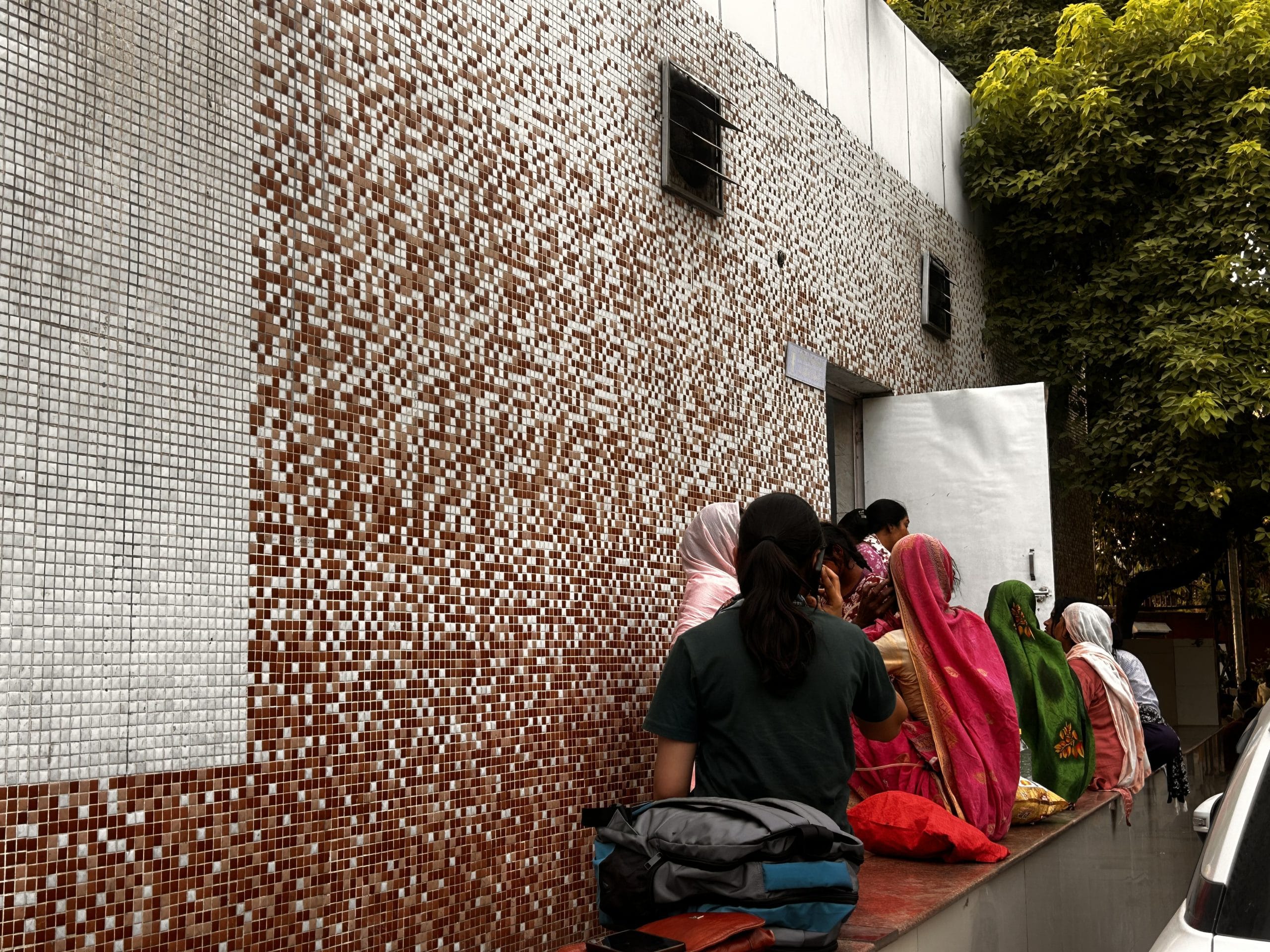 Women sit outside the AIIMS public washroom | Manisha Mondal, ThePrint