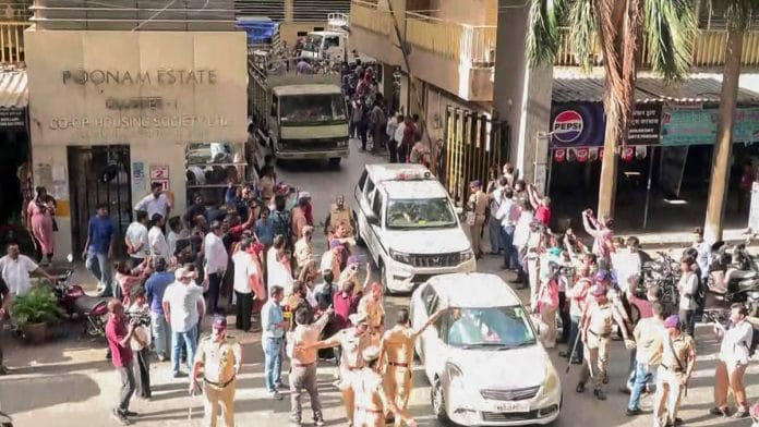 Police and residents throng the gate of Poonam Estate Cluster 1 housing society in Mira Road after clashes erupted over goats inside the premises ahead of Eid Al-Adha | ANI video grab