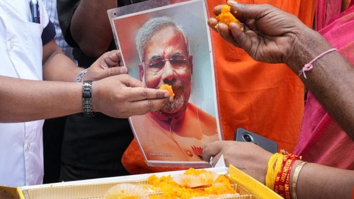 Stay tuned to ThePrint for LIVE UPDATES on Election Results for West Bengal, Tamil Nadu, Kerala, Assam and Puducherry | BJP supporters offer sweets to a portrait of Prime Minister Narendra Modi as they celebrate on the day of Assembly election results, in Kolkata, Monday, May 4, 2026 | PTI