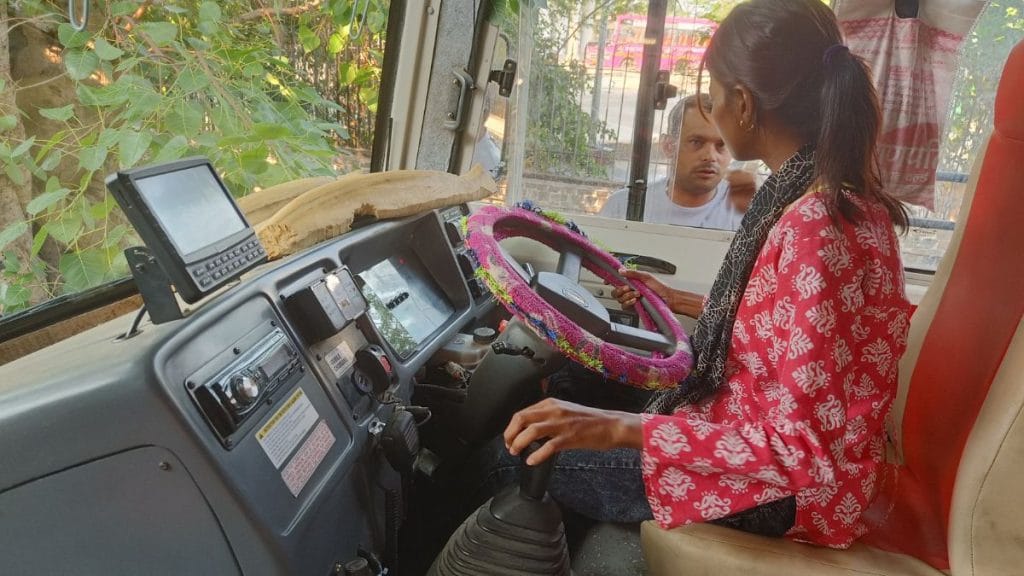 Ragini speaks to a male colleague before taking the wheel of the bus. Krishan Murari | ThePrint