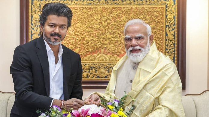Prime Minister Narendra Modi being greeted by Tamil Nadu Chief Minister C Joseph Vijay during a meeting, in New Delhi. (@PMOIndia/X) | PTI