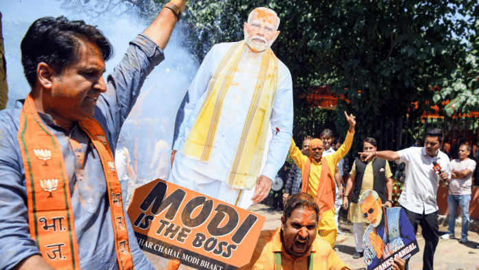 A BJP supporter celebrates the party's impressive showing in Puducherry, West Bengal and Assam. | ANI