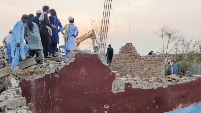Residents gather on the rubble of a damaged police post after a car bombing in Bannu, Khyber Pakhtunkhwa province, Pakistan May 10, 2026. Picture taken with a mobile phone | Reuters