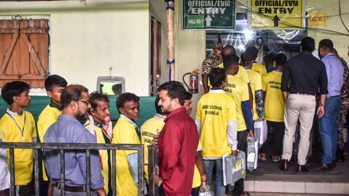 Stay tuned to ThePrint for LIVE UPDATES on Election Results for West Bengal, Tamil Nadu, Kerala, Assam and Puducherry | Election staff carry EVMs from the strong room to the counting hall during the Assam Assembly elections result day, in Kamrup district, Monday, May 4, 2026. (PTI Photo)