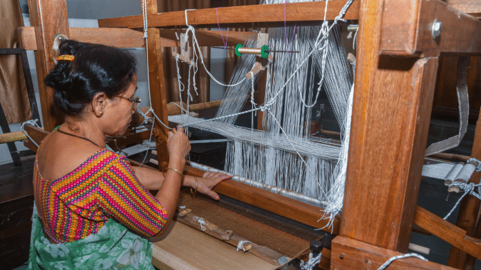 An Assamese woman weaves fabric at Vastra Bhawan on the eve of National Handloom Day, in Guwahati | ANI File