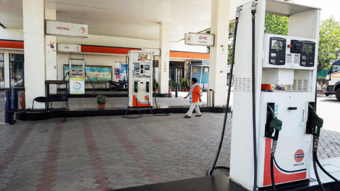 An employee walks around at a filling station after fuel prices were hiked, in Amritsar Monday | ANI