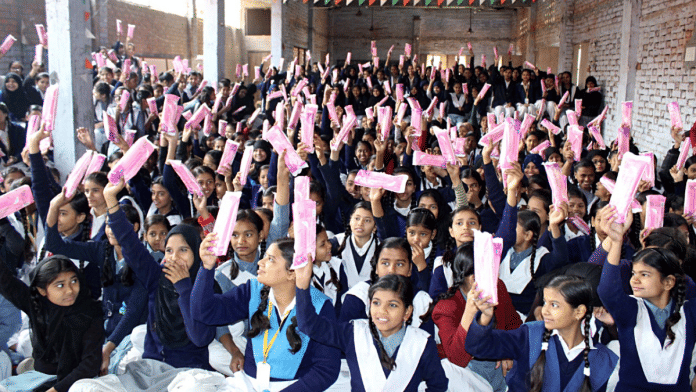 File photo of school girls with sanitary napkins distributed by social workers in Varanasi | ANI