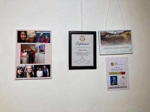 A carousel of memories with Raghu Rai hangs next to achievement certificates at the entrance| Photo: Preksha | ThePrint