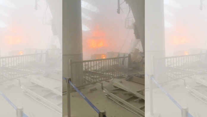 Debris lies on the floor as fire burns in the background, in the aftermath of Iranian strikes, according to the foreign ministry, at Kuwait International Airport in Kuwait City, Kuwait, June 3, 2026, in this still image obtained from a social media video. Social Media/via REUTERS
