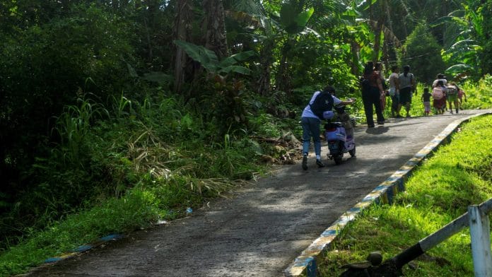 People walk as they evacuate to the highlands after Indonesia’s geophysics agency issued a tsunami warning following an earthquake in Tahuna, Sangihe Islands regency, North Sulawesi province, Indonesia, June 8, 2026. REUTERS/Stenly Pontolawokang