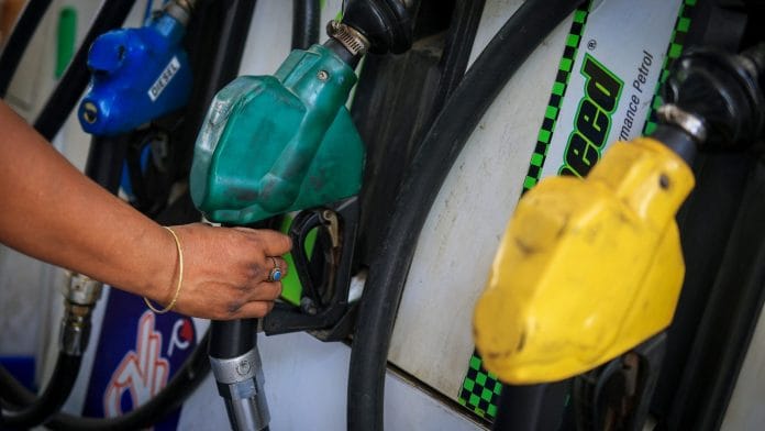 A worker holds a nozzle to pump fuel in a vehicle at a petrol pump in New Delhi, India, May 19, 2026. | REUTERS/Adnan Abidi