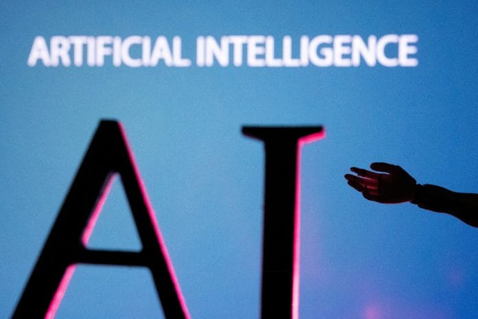 AI (Artificial Intelligence) letters and robot hand miniature in this illustration taken, June 23, 2023. | REUTERS/Dado Ruvic/Illustration
