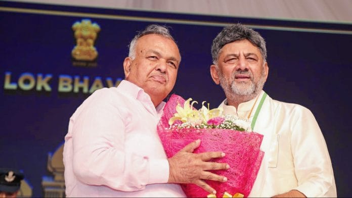 Bengaluru, Jun 03 (ANI): Newly sworn-in Karnataka Chief Minister DK Shivakumar congratulates Ramalinga Reddy as he takes the oath as a minister during the swearing-in ceremony of the new Karnataka government at Lok Bhavan, in Bengaluru on Wednesday. (@DKShivakumar X/ANI Photo)