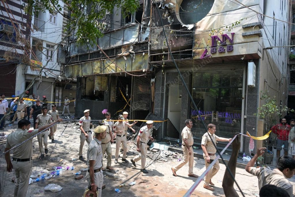 Delhi Police personnel outside Bed & Breakfast in Malviya Nagar where fire claimed 21 lives, on 3 June 2026 | Suraj Singh Bisht/ThePrint