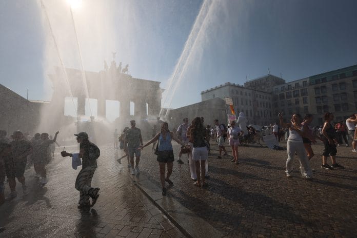 Police water canon sprays tourists at the Brandenburg Gate during a heat wave in Berlin, on June 27 Photographer Krisztian Bocsi | Bloomberg