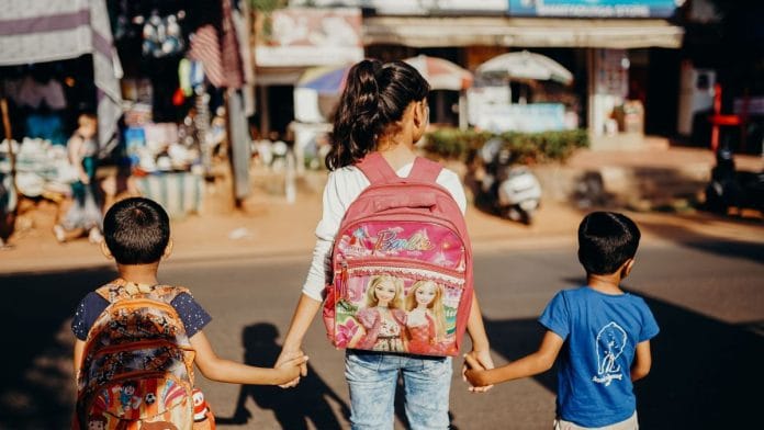 Children waiting to cross the road.