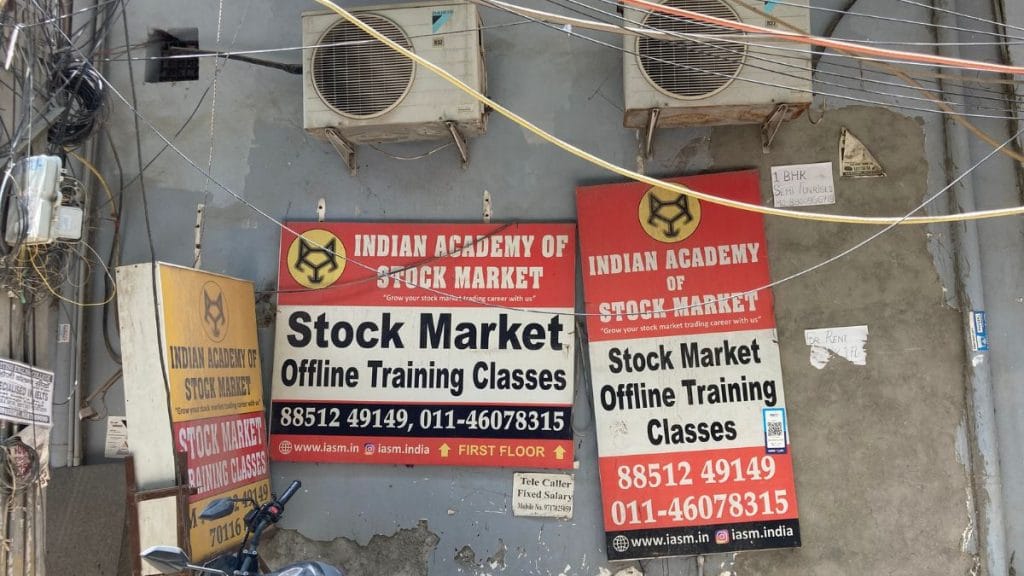 Advertisement of a trading academy huddled together in Dwarka Mor, Delhi | Photo: Preksha, ThePrint