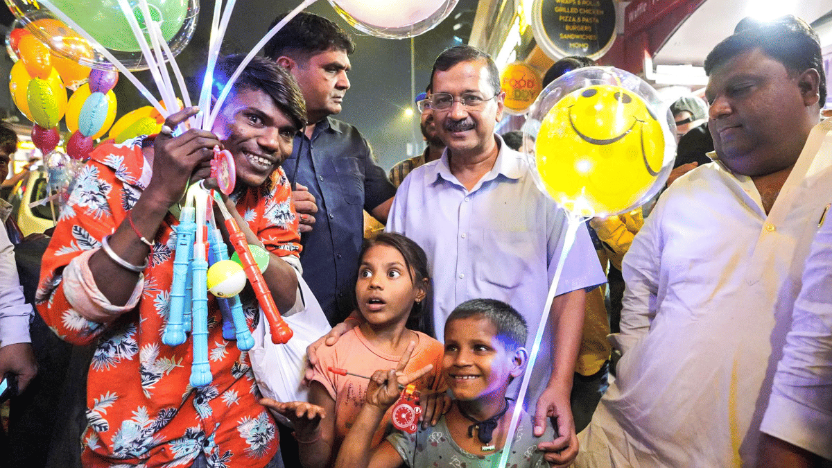 The 2024 photo shows AAP supremo and then Delhi CM Arvind Kejriwal posing for a photo with street vendors and children during his visit to Connaught Place market. | ANI file
