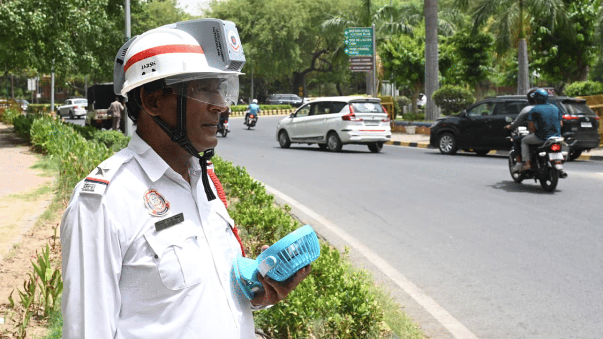 A traffic constable equipped with a mini fan and modified headgear keeps watch for errant motorists | Suraj Singh Bisht | ThePrint