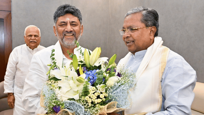 Karnataka Chief Minister-designate DK Shivakumar with outgoing state Chief Minister Siddaramaiah before the swearing-in ceremony in Bengaluru, Wednesday | PTI