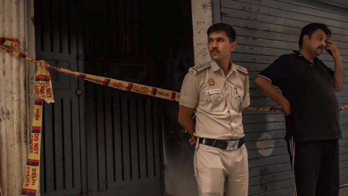 A policeman outside the five-storey residential building at Delhi's Govindpuri which caught fire | PTI