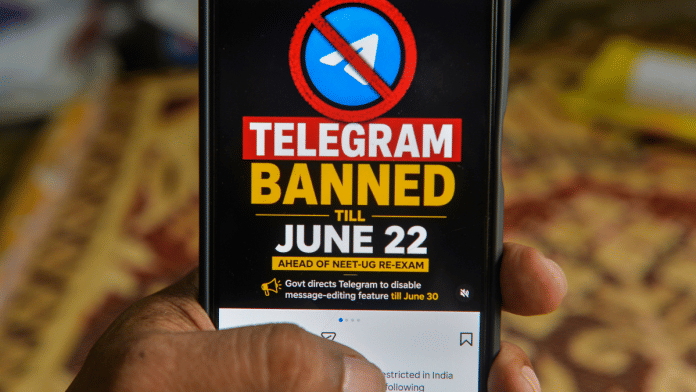 A man checks his mobile phone displaying information related to the temporary restriction on Telegram ahead of the NEET-UG re-examination, in Siliguri | PTI