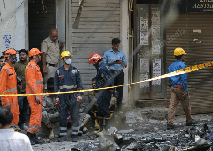 Firefighters outside the charred B&B building in Malviya Nagar | Suraj Singh Bisht | ThePrint