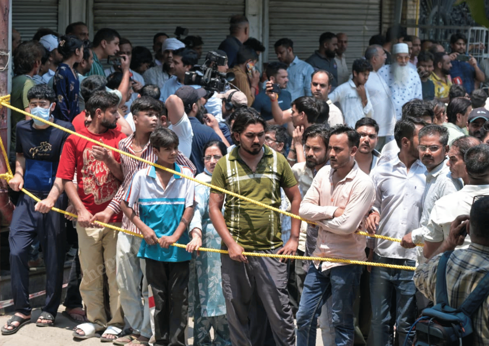 Crowds watch as rescue work continues by fire personnel and police at the B&B in Malviya Nagar where a blaze has claimed at least 21 lives | Suraj Singh Bisht | ThePrint