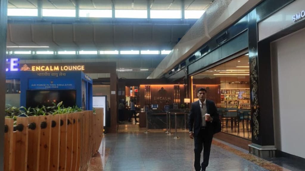 A suited professional walks out the Encalm lounge in Delhi airport's Terminal 3. Stela Dey | ThePrint