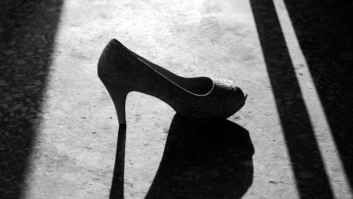 A black-and-white photo of a heel and its shadow.