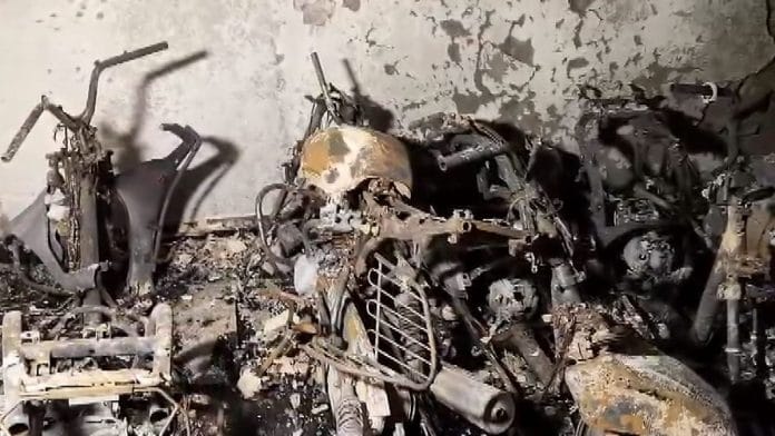 Charred remains of two-wheelers and bicycles seen after a fire broke out in a five-storey residential building in Tughlakabad Extension area in Delhi on 12 June | PTI