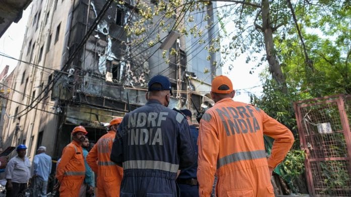NDRF officials at the site of the fire | Suraj Singh Bisht | ThePrint