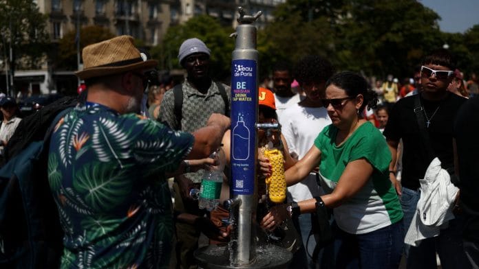 People refill water bottles from a public fountain near the Place du Trocadero during high temperatures amid a heatwave in Paris, France Tom Nicholson | REUTERS