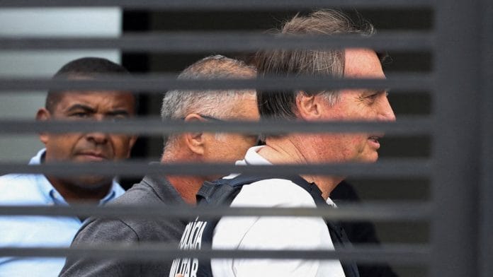 Former Brazilian President Jair Bolsonaro arrives home to begin serving house arrest following authorization by Supreme Court Justice Alexandre de Moraes, after Bolsonaro was convicted by a Supreme Court majority of plotting a coup to remain in power after losing the 2022 election, in Brasilia, Brazil March 27, 2026. | Adriano Machado /REUTERS