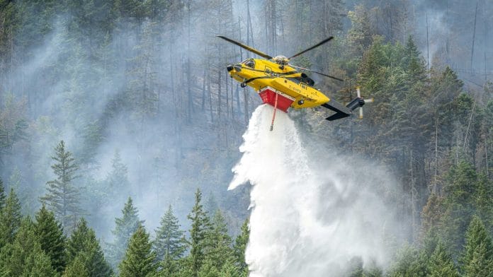 A helicopter drops water on the southern flank of the Brunswick Complex wildfires near North Bend, British Columbia, Canada, July 11, 2026. |REUTERS