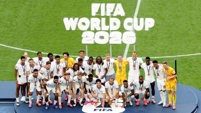 England manager Thomas Tuchel and England players wear their bronze medals as they pose for a picture on the podium during the ceremony after the match | REUTERS/Marco Bello