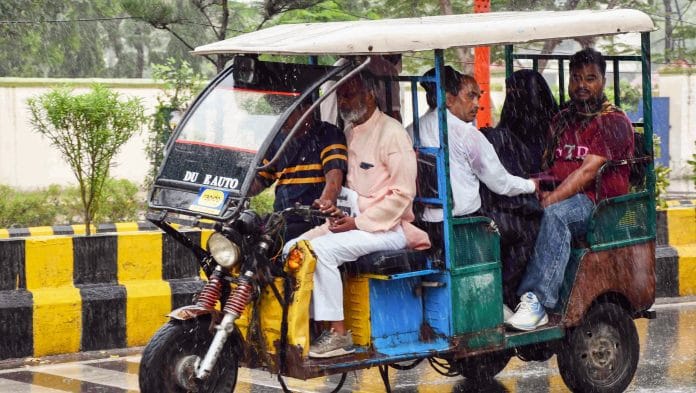 People commute in an e-rickshaw amid heavy rainfall, in Prayagraj | ANI