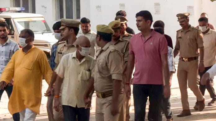Ram Mandir donations alleged embezzlement case, following the court hearing, the eight accused are being taken away from the special court, in Ayodhya on Friday. | ANI Video Grab