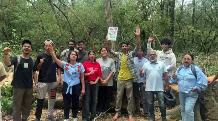 Local residents and environmental activists stand guard to protect trees set to be felled for the proposed road-widening project on the Dehradun–Rishikesh National Highway between Bhaniyawala and Ranipokhari, in Rishikesh on Sunday. | ANI Video Grab