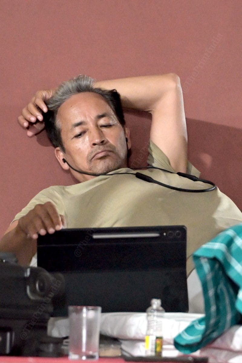Activist Sonam Wangchuk is looking at something on his tablet | Photo: Suraj Singh Bisht | ThePrint