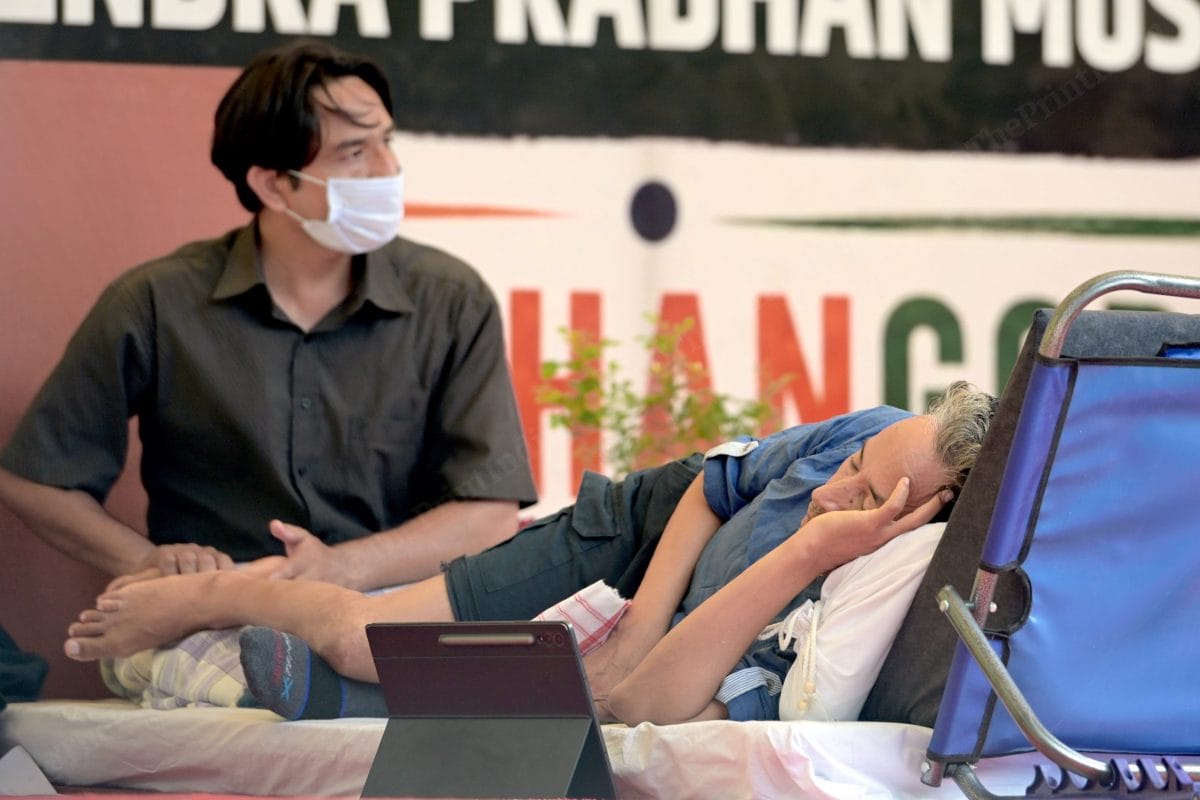 A supporter or Volunteer of Cockroach Janata Party massaging Sonam Wangchuk feet | Photo: Suraj Singh Bisht | ThePrint