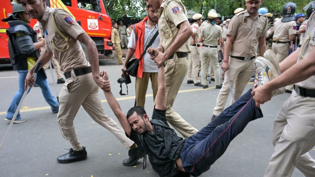 A protester is carried away as Delhi Police carry out lathicharge during the CJP march to Parliament | Praveen Jain | ThePrint