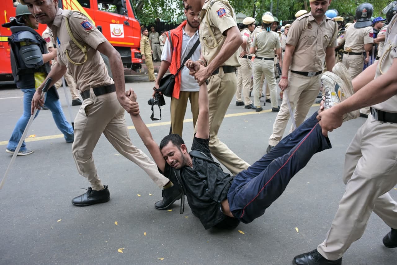 A protester is carried away as Delhi Police carry out lathicharge during the CJP march to Parliament | Praveen Jain | ThePrint