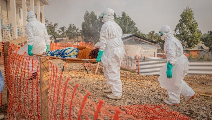 Healthcare workers carry on a stretcher an Ebola patient in Bunia, the Democratic Republic of Congo