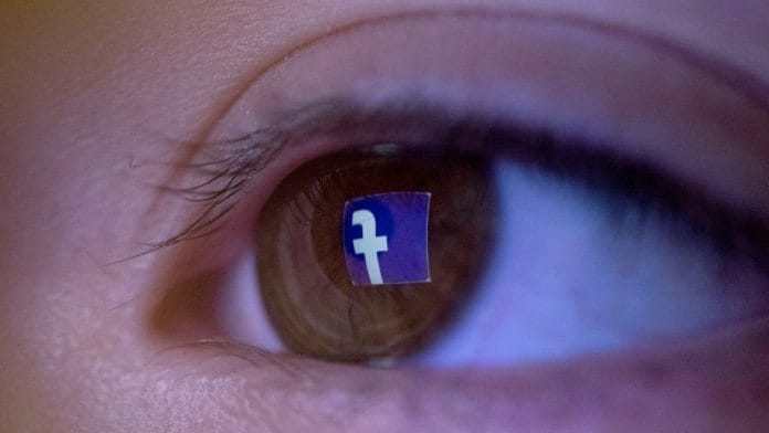 The Facebook logo reflected in a child's eye. | Brent Lewin/Bloomberg